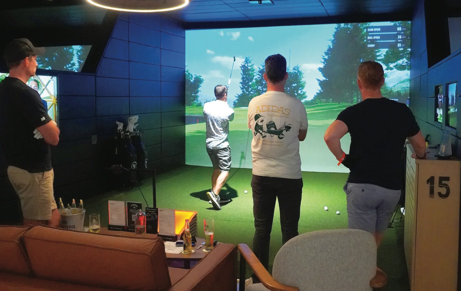 Guests using a golf simulator at Five Iron Golf Dubai